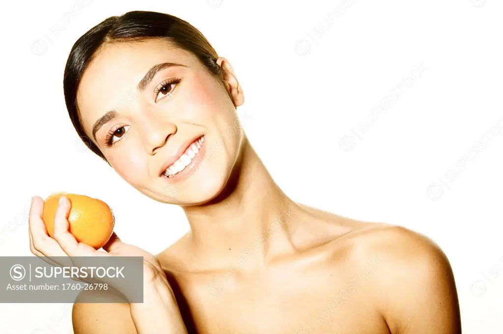 Hawaii, Studio headshot of a beautiful girl holding an orange.