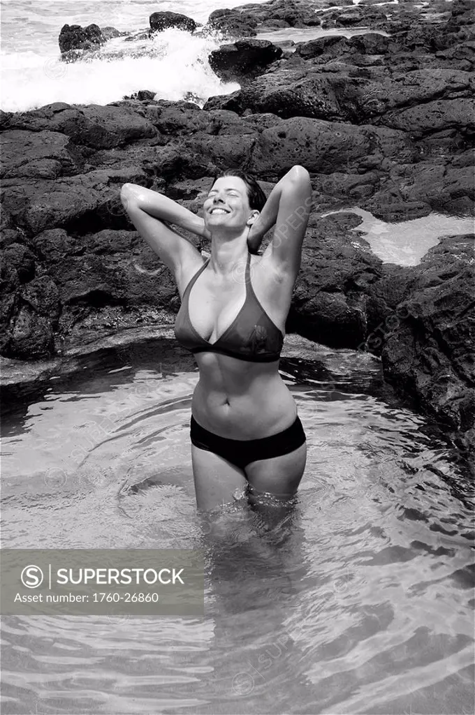 Hawaii, Kauai, Kauapea Beach Secret Beach Beautiful woman in the water, black and white.