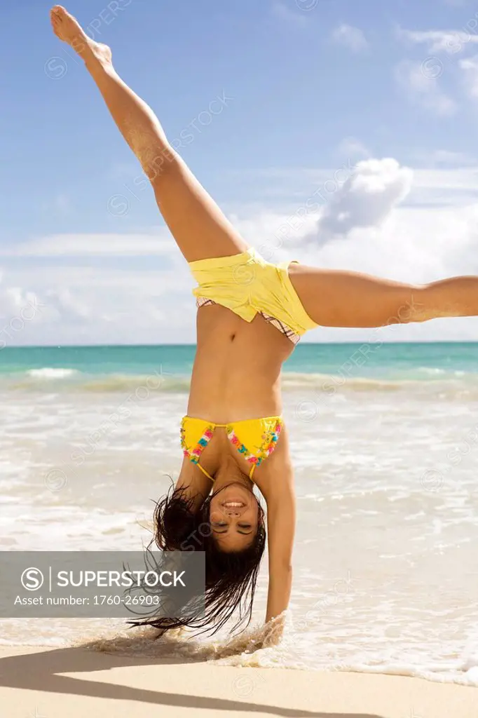 Hawaii, Oahu, Attractive young woman on the beach having fun.