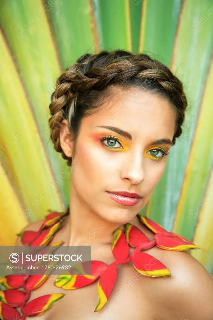 Hawaii, Oahu, Headshot of Attractive Beautiful Female with braided hair and heliconia flowers around her neck.