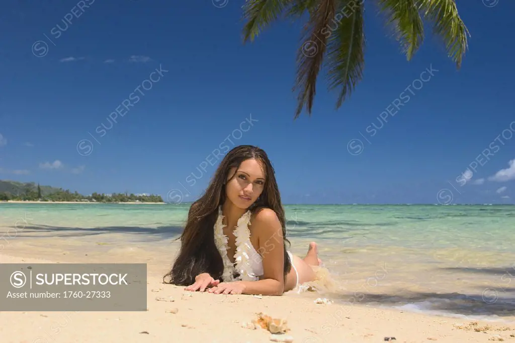 Hawaii, Oahu, Sexy Polynesian woman lounging on a tropical beach