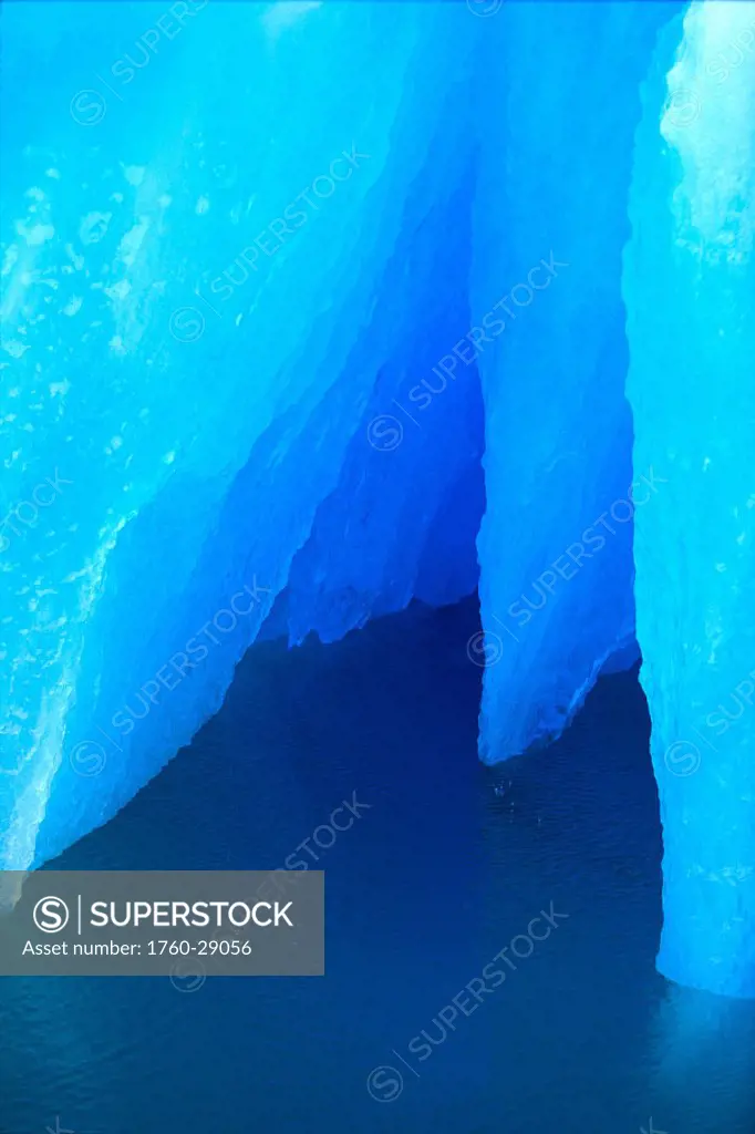 AK, Inside Passage, Closeup detail of iceberg, tinged blue, calm ocean