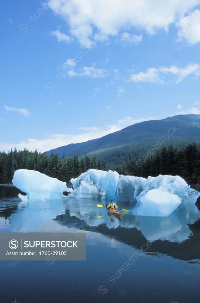Alaska, Tongass National Forest, Tracy Arms Terror Wilderness, Kayaker passing through icebergs.
