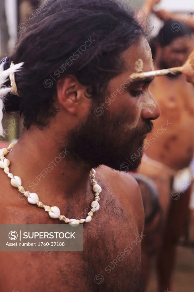 Easter Island, Tapati Festival, Local man having paint applied to face, Rapa Nui culture.