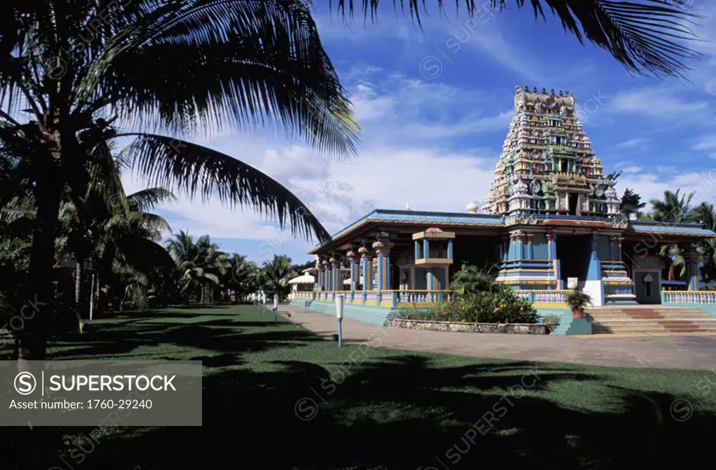 Fiji, Nadi Bay, Sri Siva Subramaniya Swami Temple, framed by palm trees and grass.