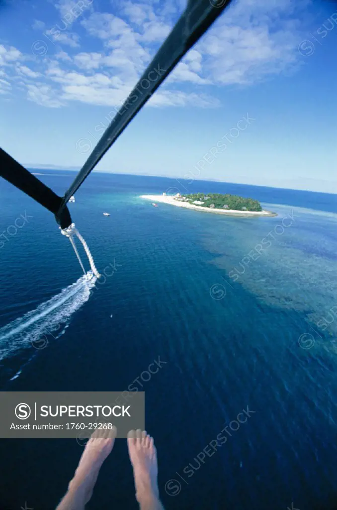 Fiji aerial fr parasail boat cord string & feet foreground Beachcomber Island distance background
