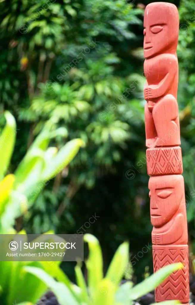 French Polynesia, Tahiti, Paea, Marae Arahuhu, /nview of statue with green vegetation