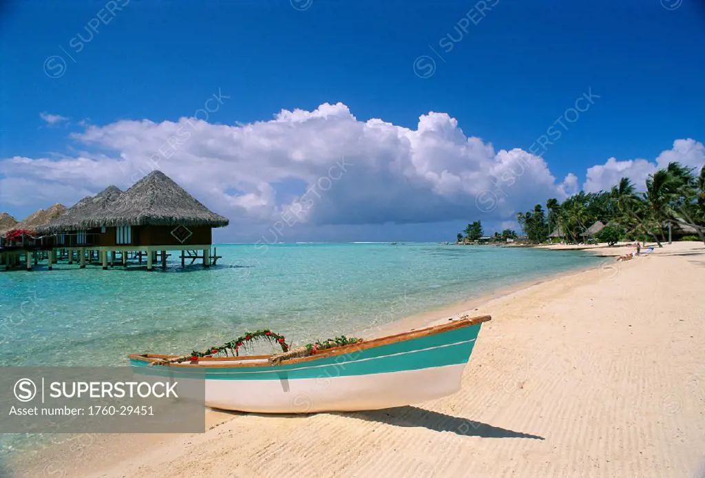 FP, Tahiti, Bora Bora, Moana Beach Parkroyal Resort canoe on white sand, bungalows in lagoon