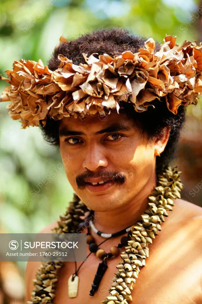 French Polynesia, Tahiti, Polynesian Man in native headdress, dried plants.
