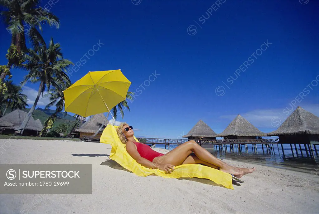 French Polynesia Moorea Bali Hai, caucasian woman relaxing on the beach