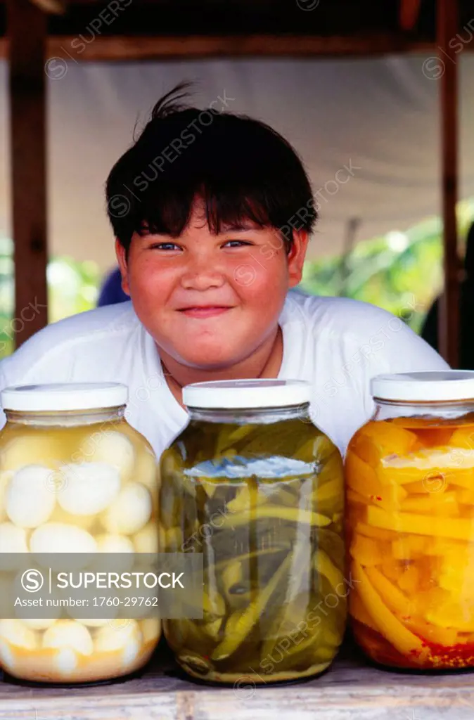 Guam, Merizo, Young boy smiling, Duda´s Vegetable Stand, pickled vegetables