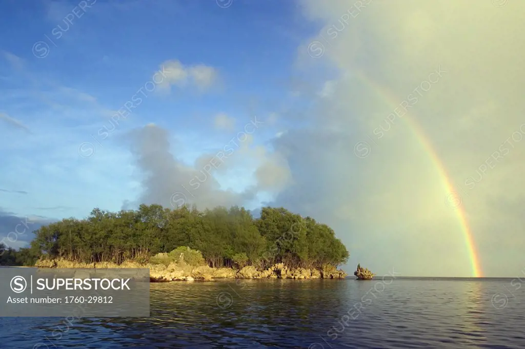 Micronesia, Palua, Rainstorm approaches a small island, rainbow overhead.