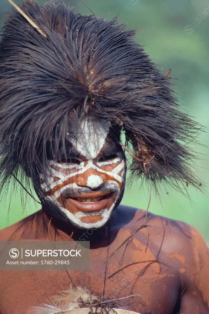 Papua New Guinea, Head shot of young man, face with war paint and wild hair