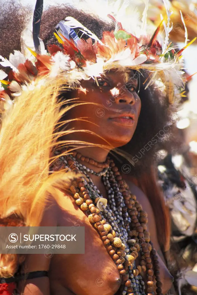 Papua New Guinea, Topless native woman with necklaces and feather headdress NO MODEL RELEASE
