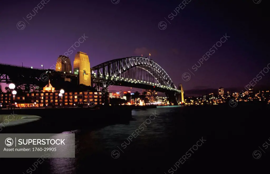 Australia, New South Wales, Sydney, Harbour Bridge at night, city lights in distance.