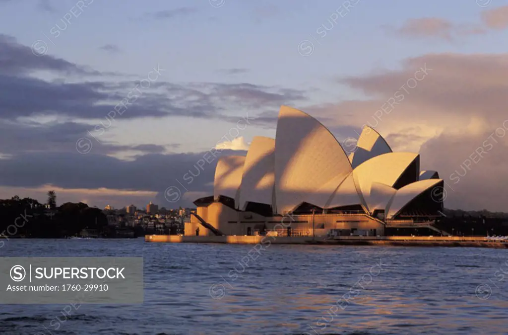 Australia, New South Wales, Sydney, Opera House in late afternoon warm lighting.