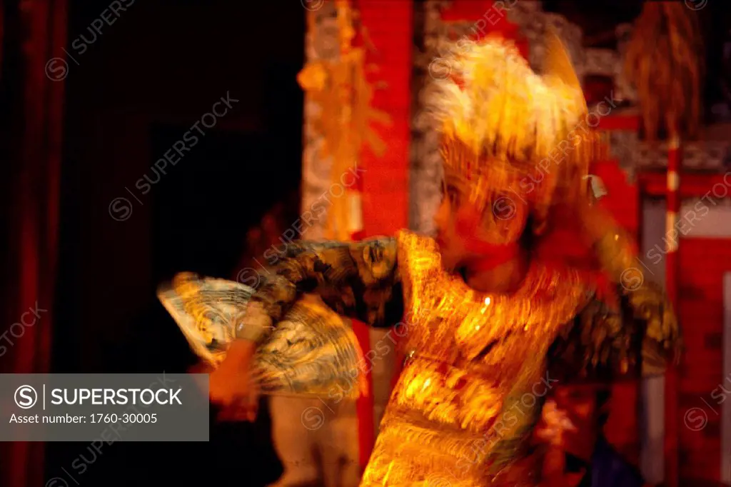 Indonesia, Bali, young girl dances with fan, blurred action