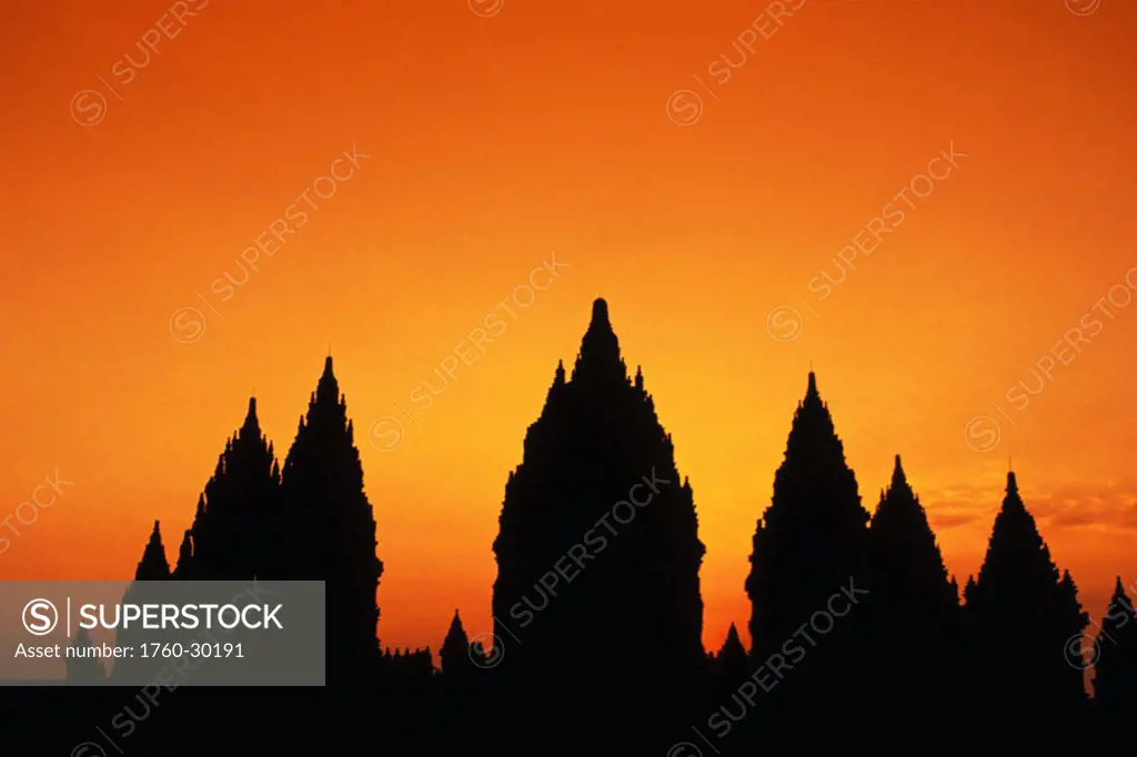 Indonesia, Java, Prambanan, Shiva Mahadeva temple silhouetted at sunset