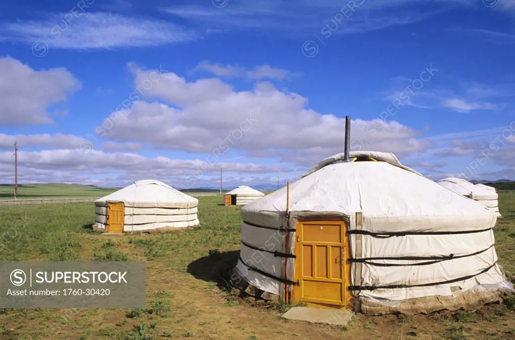Mongolia, Ger Ranch, Traditional Nomadic homes on flat grassy countryside.