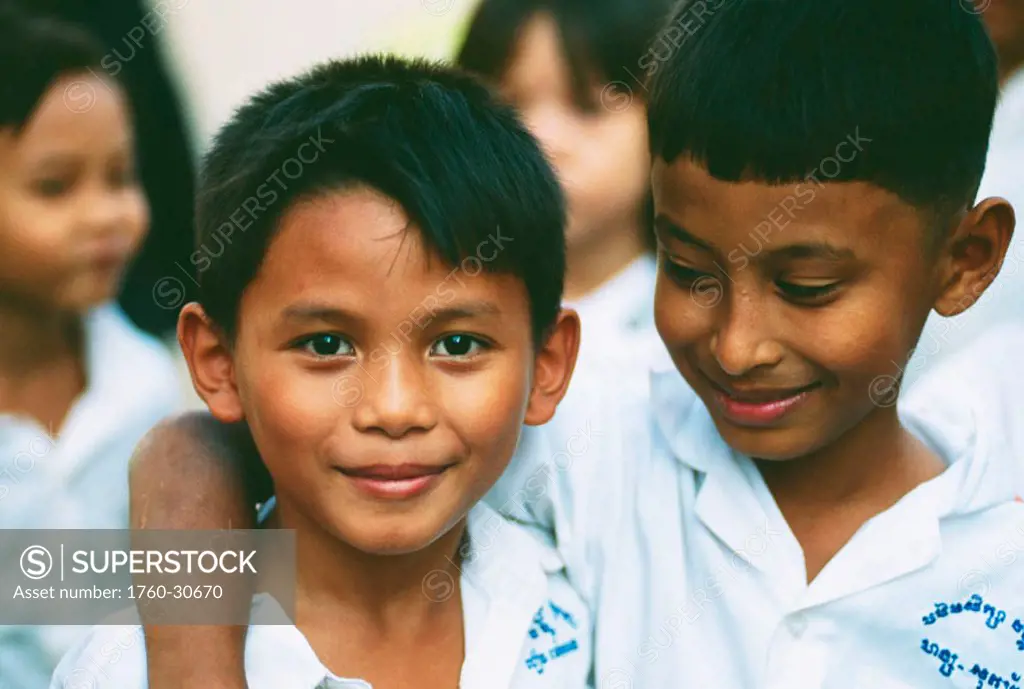 Cambodia, Phnom Phen, Close-up of two boys in a group of young school children.