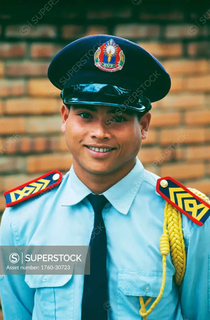 Laos, Luang Prabang, Portrait of a uniformed security guard.