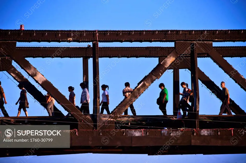 Thailand, Kanchanaburi, Infamous bridge over the river Kwae, tourist walking across.