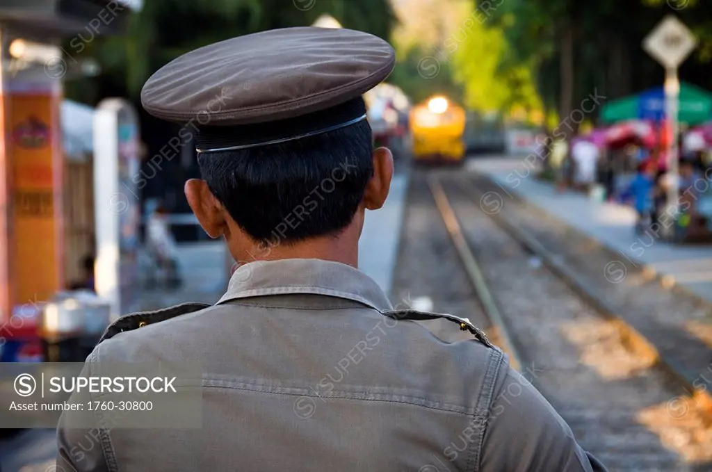 Thailand, Kanchanaburi, WW2´s infamous Death Railway, A train guard watches as a passenger train prepares to cross the river Kwai.