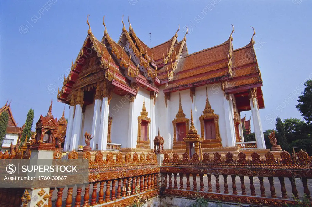 Thailand Lop Buri exterior of temple architecture w/ fence detail surrounding, pale blue sky