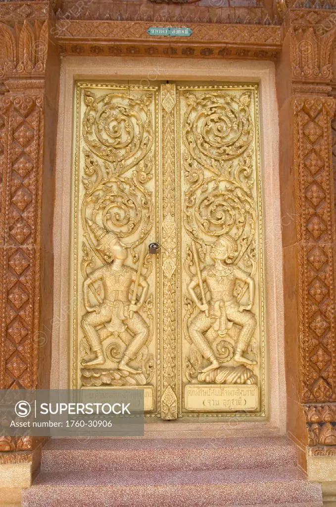 Thailand, Nong Bua Lumphu, intricate detail of carved golden temple doors.