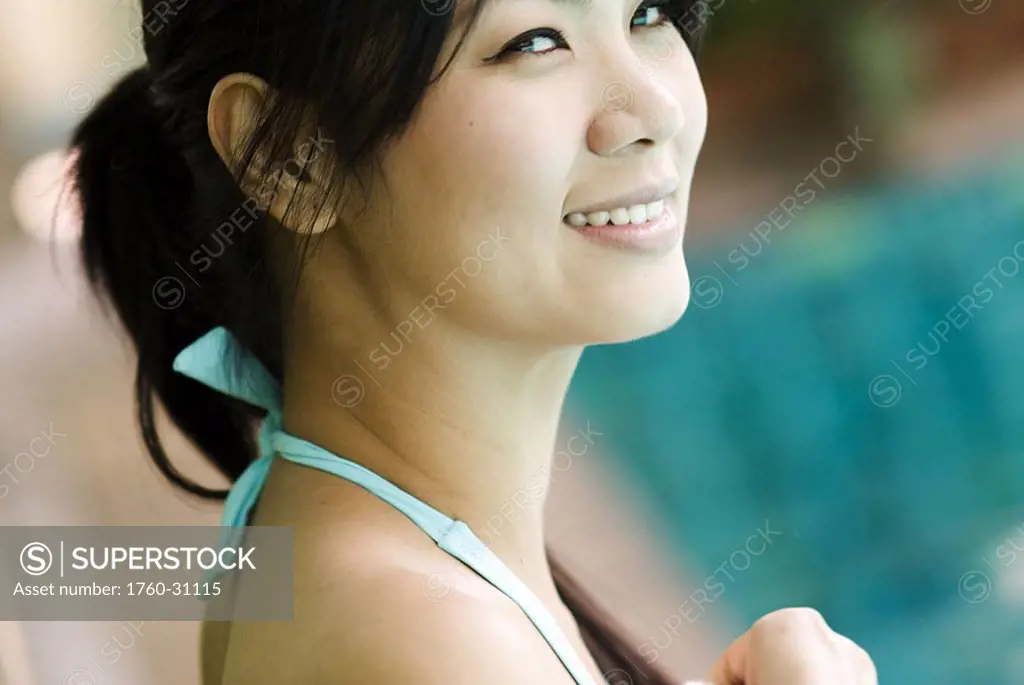 Thailand, Bangkok, Thai woman next to pool