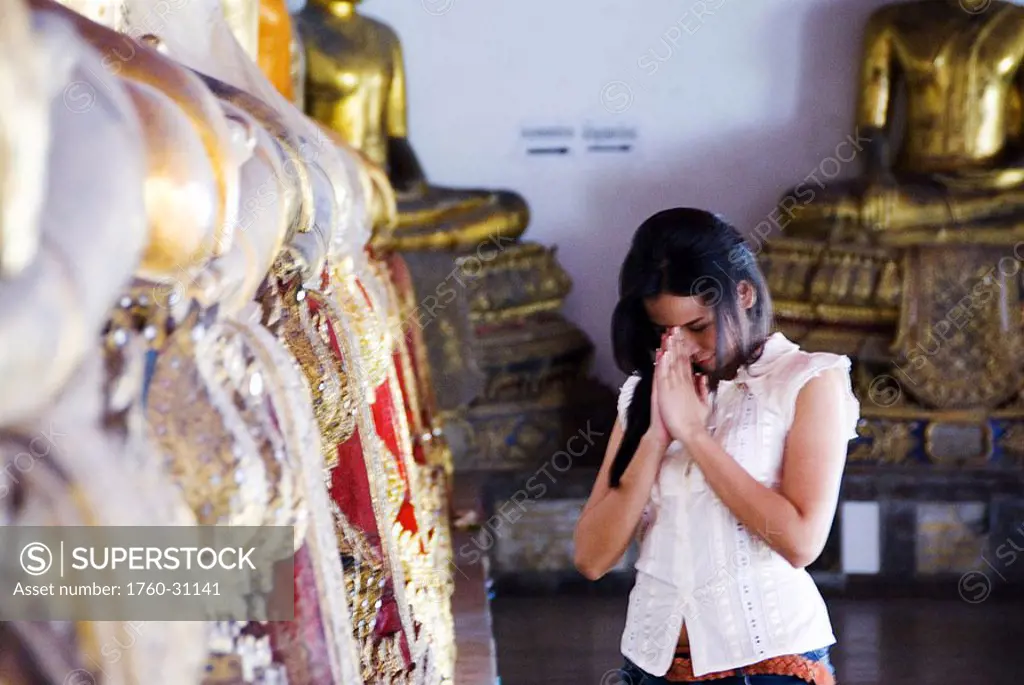 Thailand, Bangkok, Thai woman praying at a temple