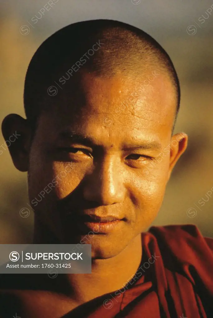 Burma (Myanmar), Pagan, Headshot of Buddhist monk in afternoon lighting.