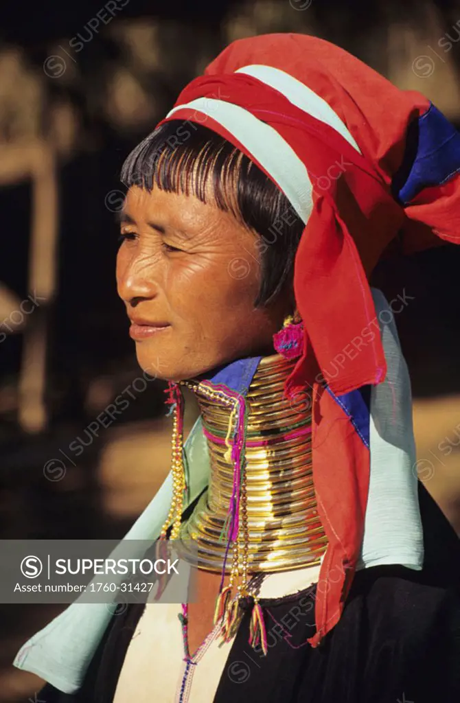 Burma (Myanmar), Kaungdine Village, Inle Lake, Padaung tribal woman with many neck rings, view from side.