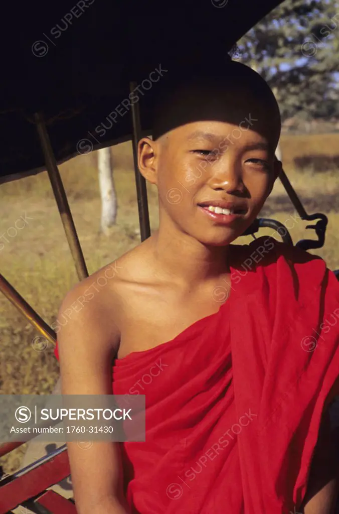 Burma (Myanmar), Bagan, headshot of young Buddist monk in carriage.