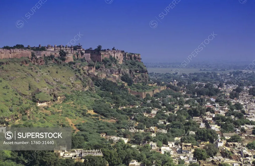 India, city of Gwalior, Man Singh Palace on hillside above, clear blue skies.