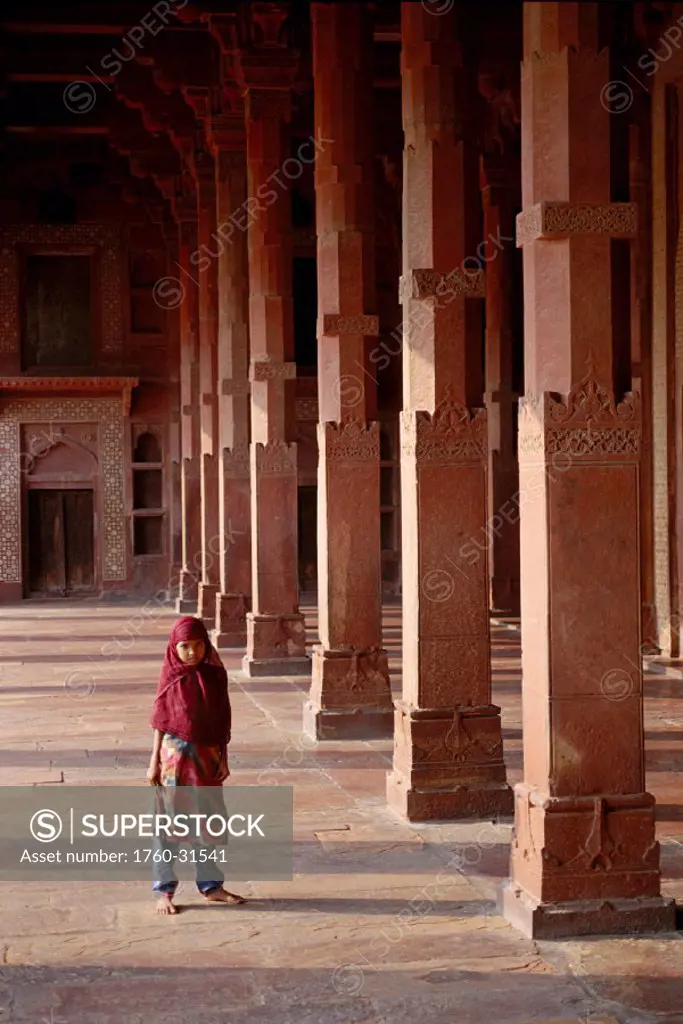 India, child stands in hallway of Agra Fatehpur Sikri Dargah Mosque