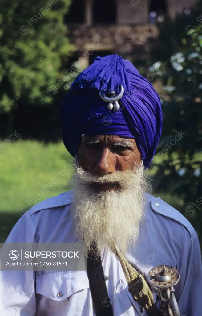 India, Gwalior, Sikh man senior with white beard and wearing purple turban.