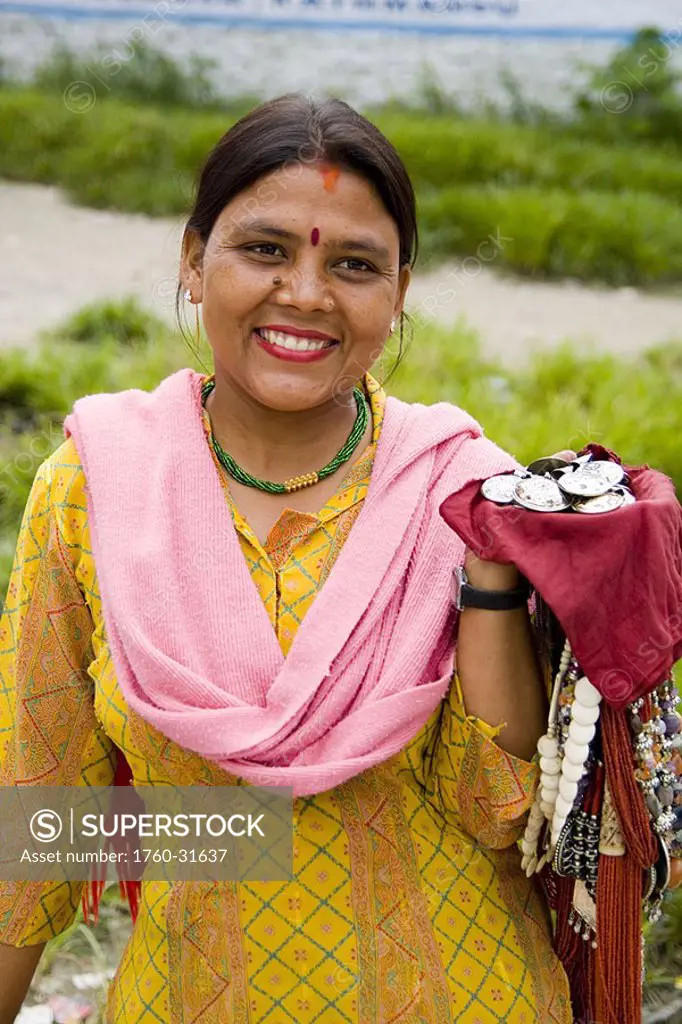India, New Delhi, Beautiful woman selling items at Laxmi Narayan Temple near huge Chartarpur Road Temple
