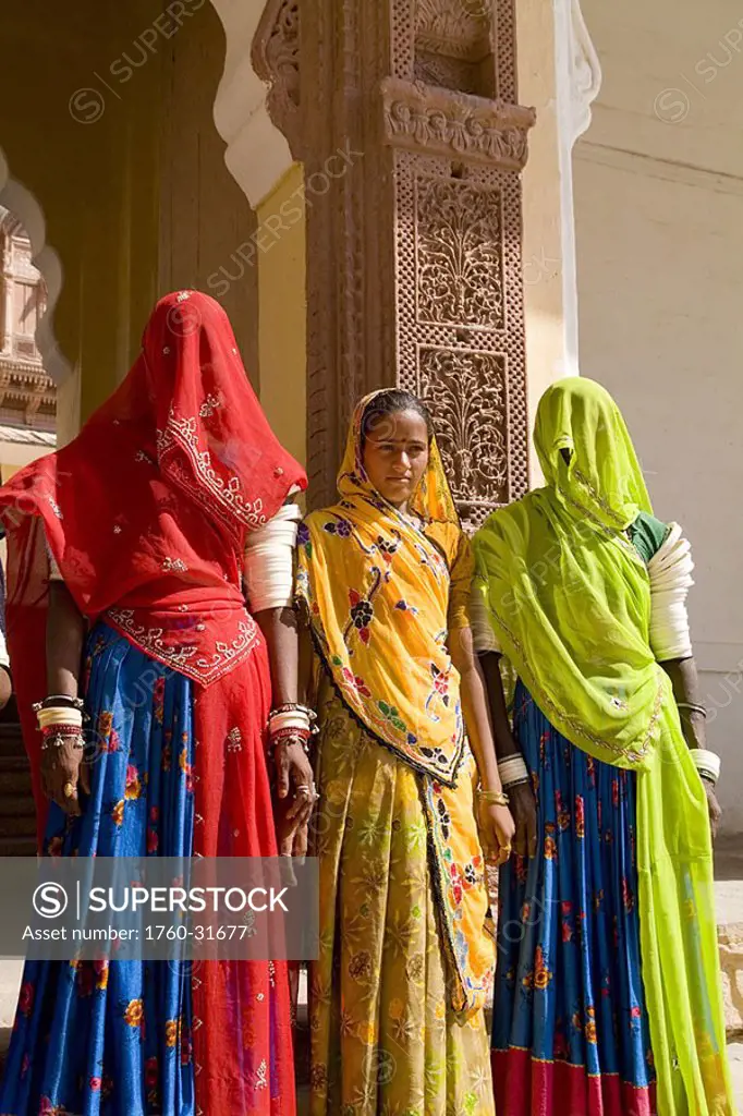 India, Rajasthan, Jodhpur at Fort Mehrangarh, women in colorful saris at the door of Fort Palace