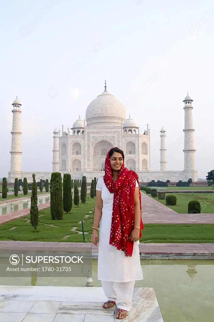 India, Agra, Hindu woman wearing sari and viel standing before the Taj Mahal