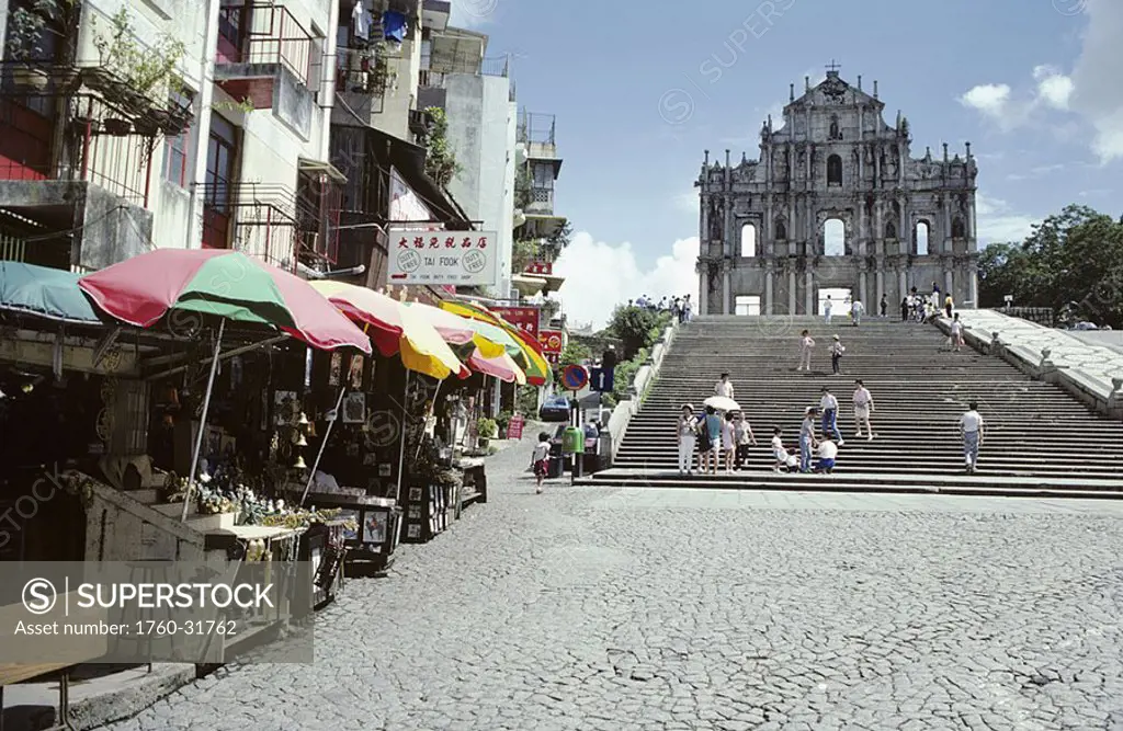 Macau, Saint Paul´s cathedral ruins, Visitors on stairway, Tourist shops along cobblestone road