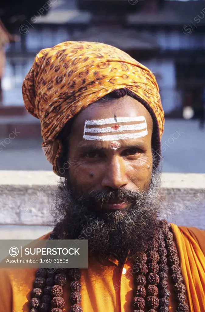 Nepal, Kathmandu, close-up of Hindu Holy man wearing orange turban, forehead painted with white stripes.
