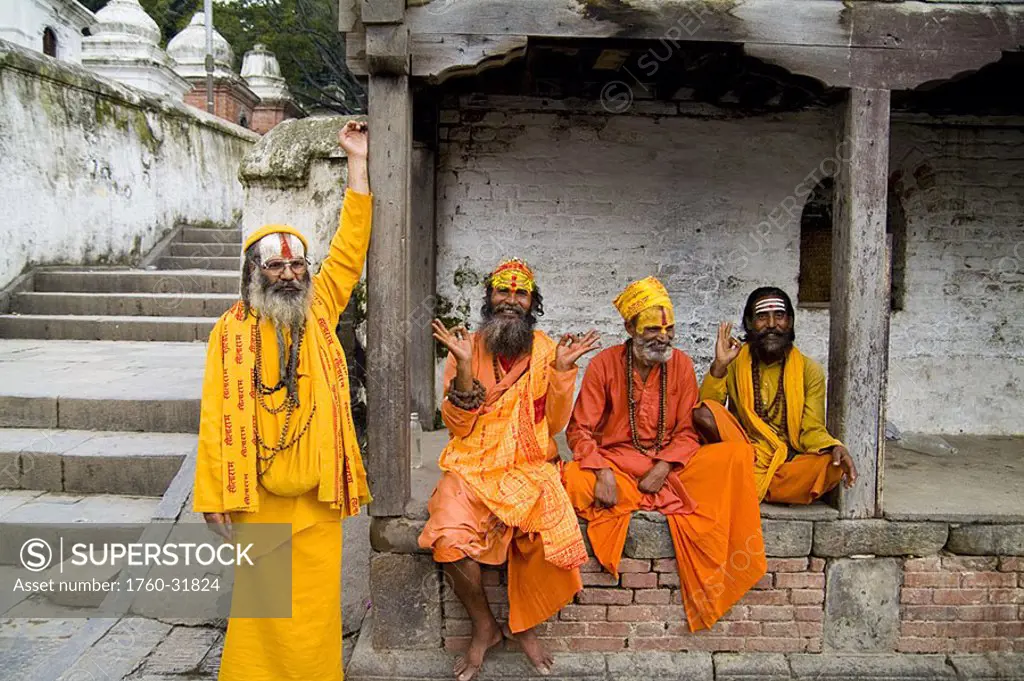 Nepal, Kathmandu, religious men at Pashupatinath holy Hindu place on Bagmati River, painted and colorfully dressed