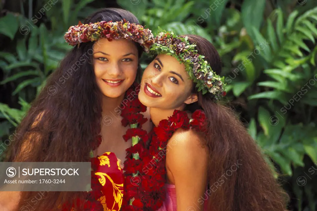 Hawaii, Two beautiful Polynesian women with haku lei, tropical setting