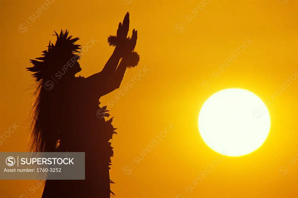 Kahiko hula at sunset, side view of woman silhouetted against orange sky, C1456 sunball