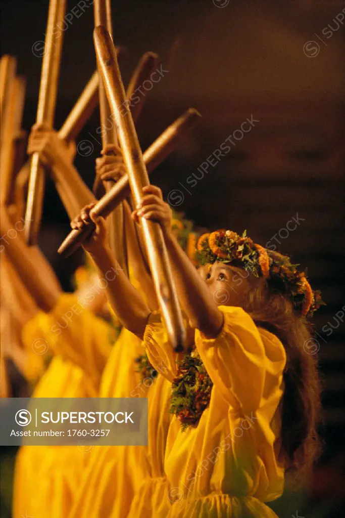 Side vu of keiki hula girls dancing w/ pu´ili (split bamboo) colorful leis C1449