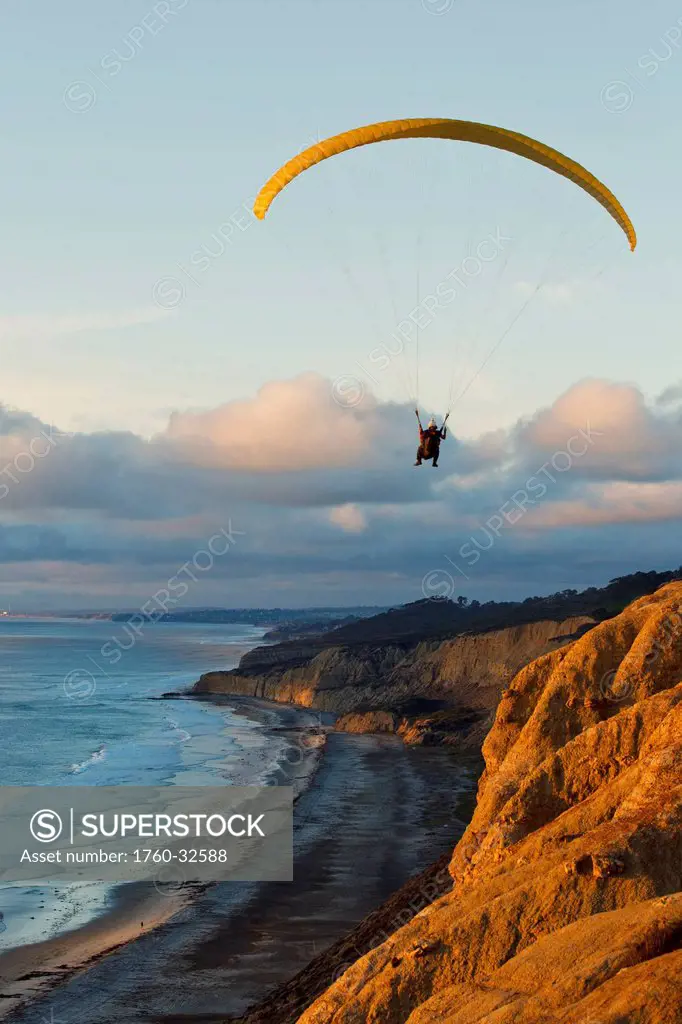 California, La Jolla, Paraglider Flying Over Ocean Cliffs At Sunset. Editorial Use Only.