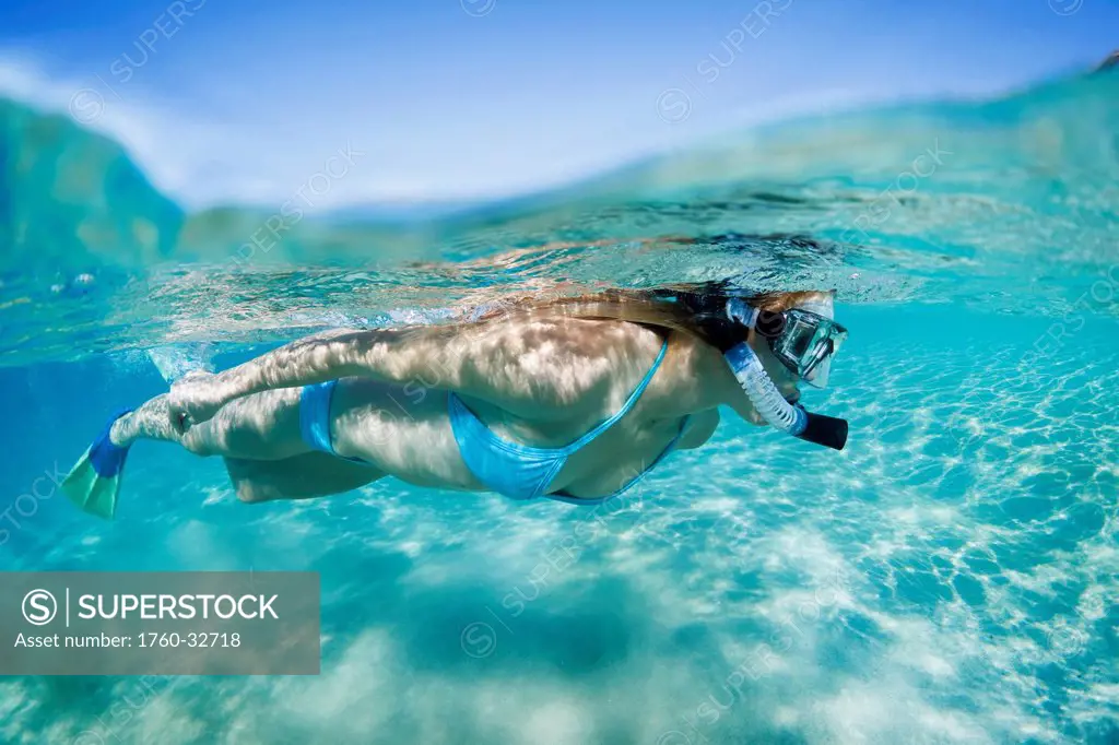 Hawaii, Maui, Makena, Young Woman Snorkles In Shallow Waters.