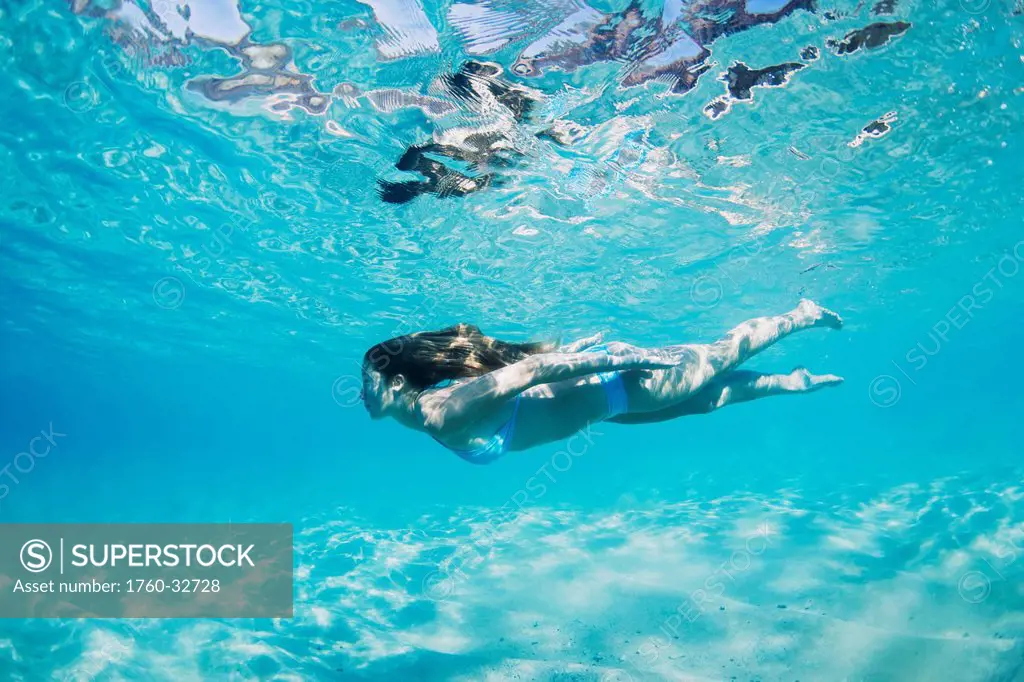 Hawaii, Maui, Makena, Young Woman Swimming Near Ocean Surface.