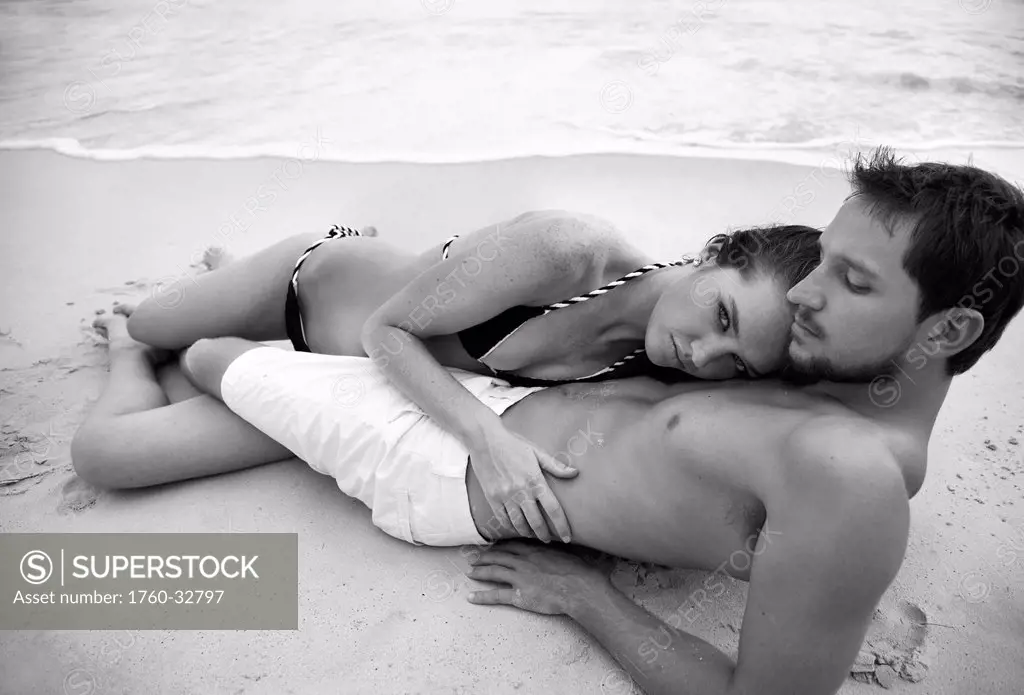 Hawaii, Oahu, Sexy Attractive Young Couple Holding And Laying Together On The Beach, Black & White Version